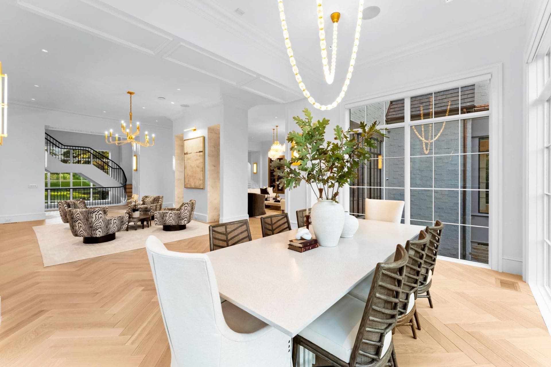 Dining room with staircase and gold chandeliers