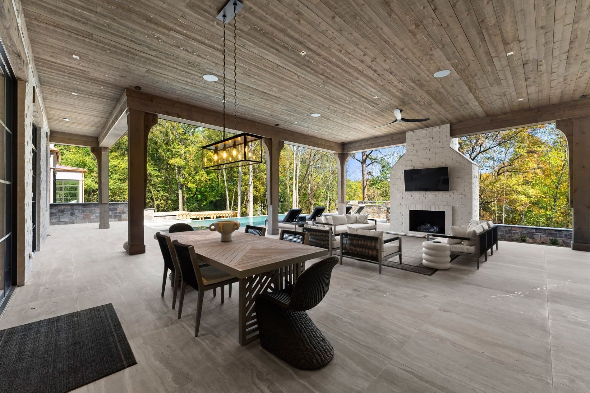 Covered patio with outdoor dining and fireplace