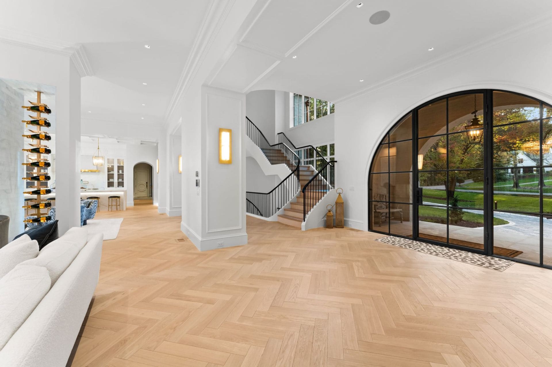 Foyer with sweeping staircase and arched window