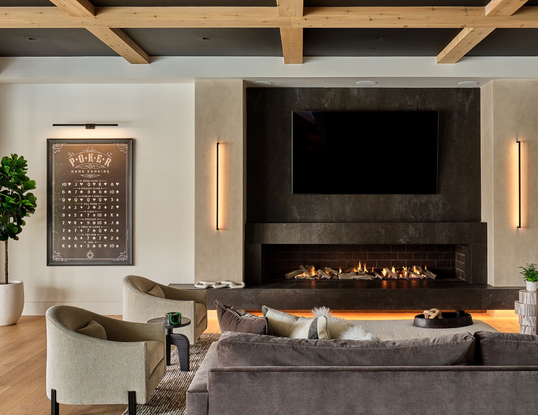 Game room with linear fireplace and exposed beam ceiling