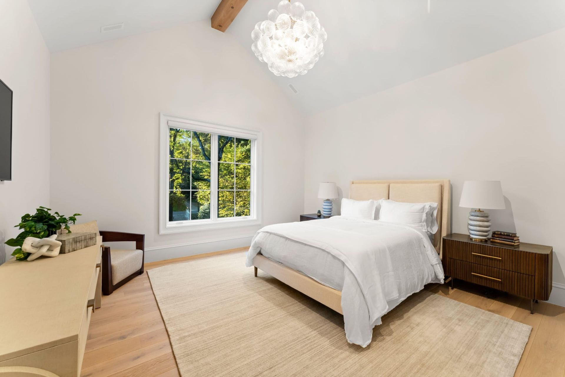 Guest bedroom with neutral tones and bubble chandelier