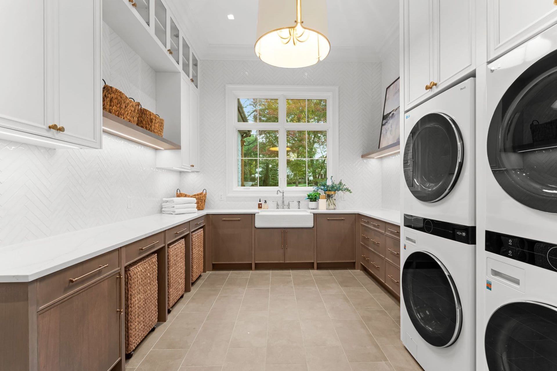 Laundry room with herringbone tile and farmhouse sink