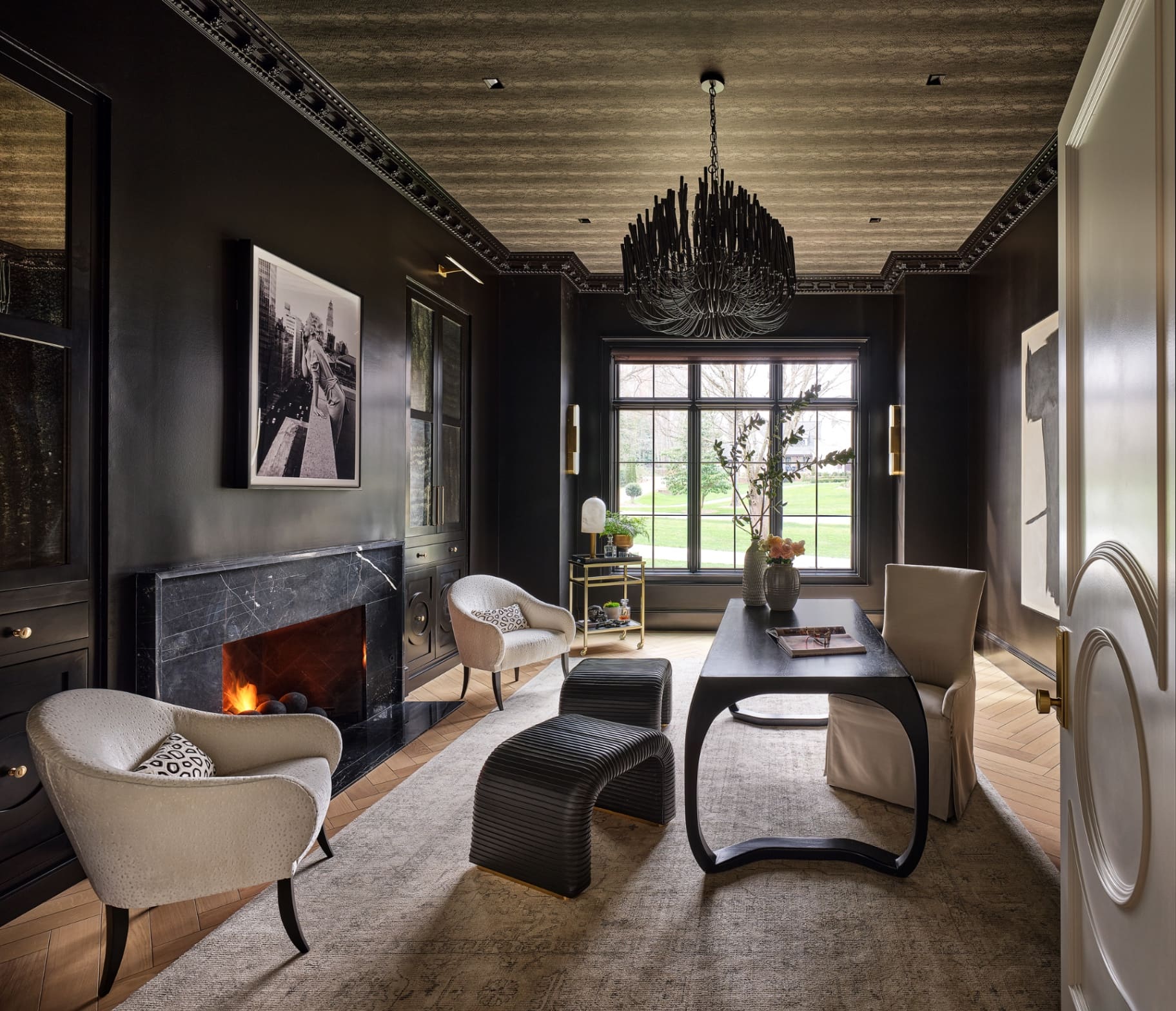 Private office with marble fireplace and designer chandelier