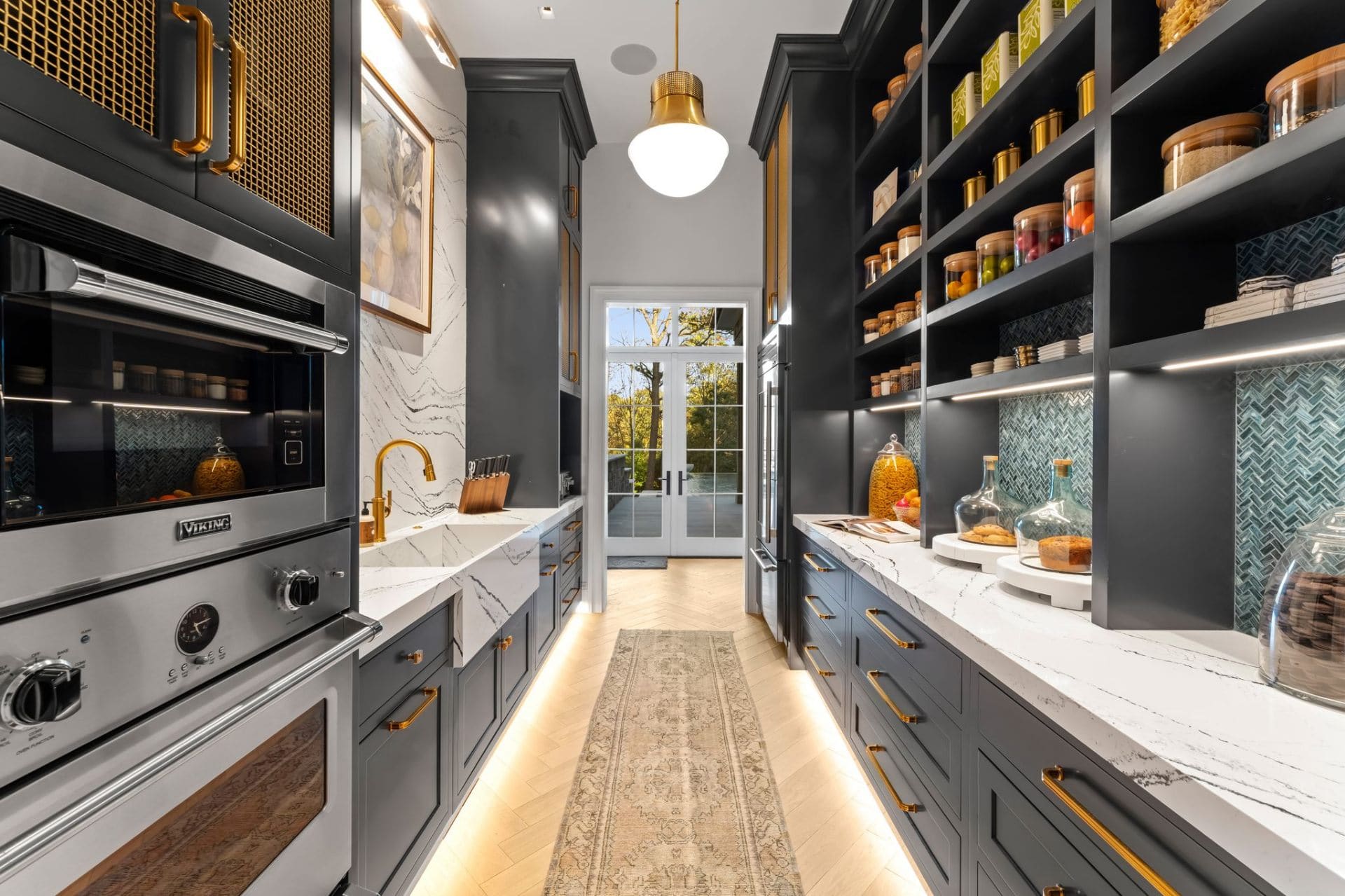Dark pantry with Viking ovens and gold hardware