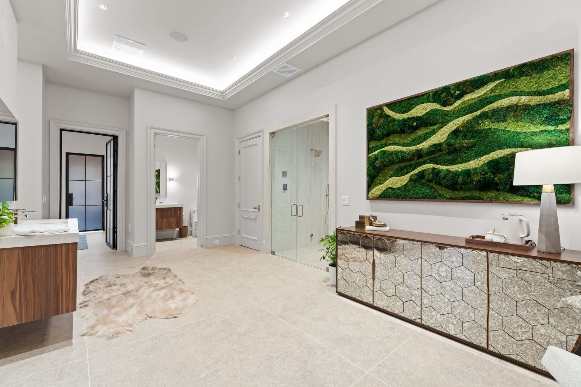Primary bath with moss art and mirrored credenza