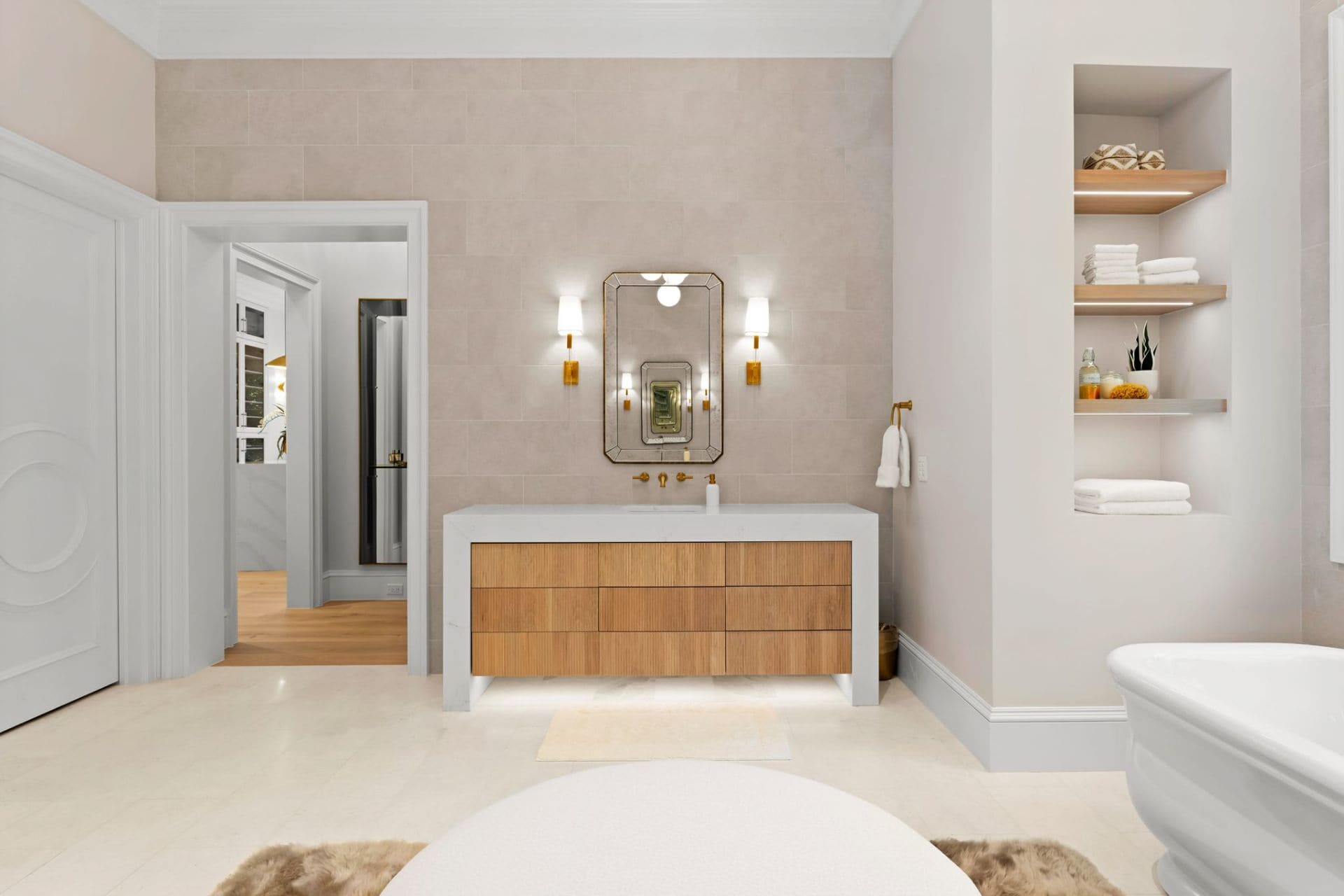 Primary bath vanity detail with brass sconces